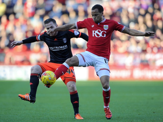 Elliot Bennett of Bristol City is tackled by Ross McCormack of Fulham during the Sky Bet Championship match between Bristol City and Fulham at Ashton Gate on October 31, 2015