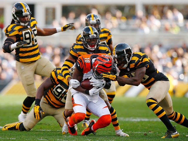 A.J. Green #18 of the Cincinnati Bengals is tackled by Antwon Blake #41 and Robert Golden #21 of the Pittsburgh Steelers during the 2nd quarter of the game at Heinz Field on November 1, 2015