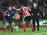 Graziano Pelle of Southampton performs a haka style celebration with Southampton sports therapist Graeme Staddon as he scores their second goal as Ronald Koeman manager of Southampton looks on during the Barclays Premier League match between Southampton a