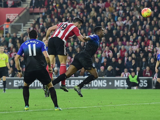 Graziano Pelle of Southampton out jumps Sylvain Distin of Bournemouth to score their second goal during the Barclays Premier League match between Southampton and A.F.C. Bournemouth at St Mary's Stadium on November 1, 2015 in Southampton, England.