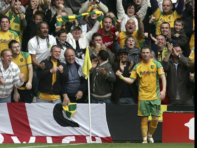 Jamie Cureton of Norwich celebrates scoring their second goal with the fans during the Coca-Cola Championship match between Norwich City and Ipswich Town at Carrow Road on November 4, 2007