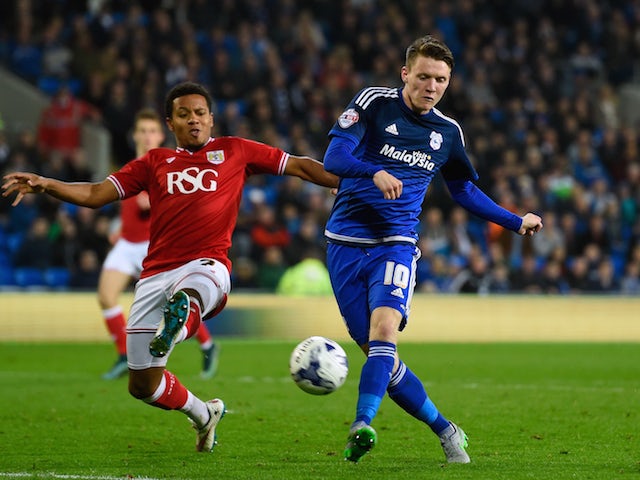 Joe Mason of Cardiff (r) shoots at goal during the Sky Bet Championship match between Cardiff City and Bristol City at Cardiff City Stadium on October 26, 2015 in Cardiff, United Kingdom.
