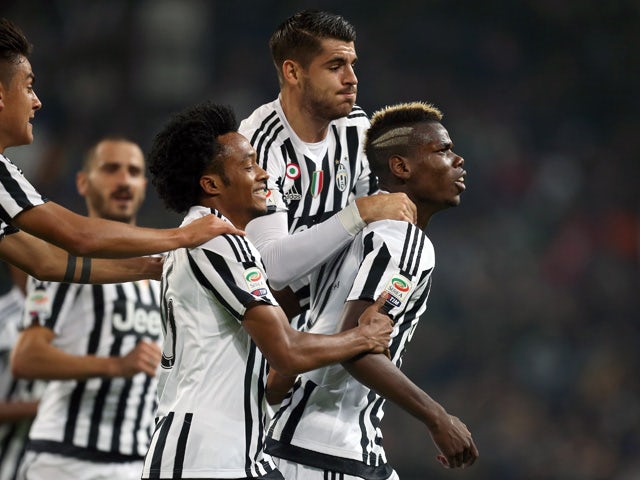 Juventus' French midfielder Paul Pogba (R) celebrates with his teammates after scoring during the Italian Serie A football match Juventus Vs Torino on October 31, 2015