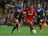 Roberto Firmino of Liverpool is closed down by Matt Ritchie of Bournemouth during the Capital One Cup Fourth Round match between Liverpool and AFC Bournemouth at Anfield on October 28, 2015 in Liverpool, England.