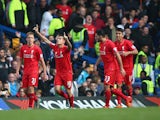 Philippe Coutinho (2nd L) of Liverpool celebrates scoring his team's second goal during the Barclays Premier League match between Chelsea and Liverpool at Stamford Bridge on October 31, 2015