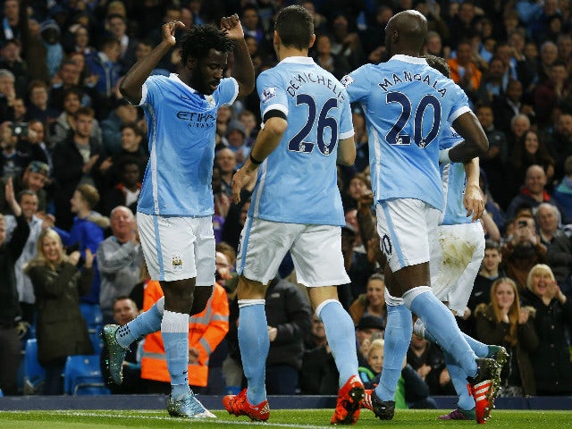 Manchester City's Ivorian striker Wilfried Bony (L) celebrates with teammates after scoring the opening goal during the English League Cup fourth round football match between Manchester City and Crystal Palace at The Etihad Stadium in Manchester, north we