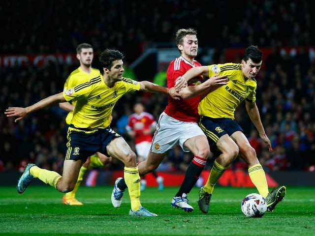 James Wilson of Manchester United takes on George Friend (L) and Daniel Ayala of Middlesbrough during the Capital One Cup Fourth Round match between Manchester United and Middlesbrough at Old Trafford on October 28, 2015 in Manchester, England.