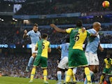 Manchester City's Argentinian defender Nicolas Otamendi (L) jumps to head the ball home for the opening goal of the English Premier League football match between Manchester City and Norwich City at The Etihad Stadium in Manchester, north west England on O