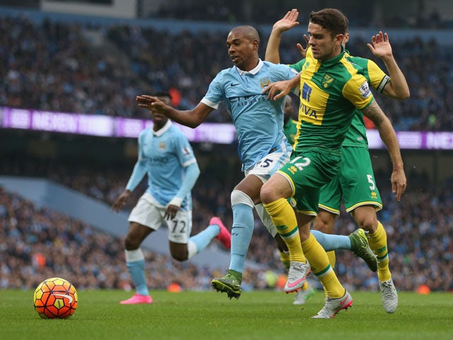 Fernandinho of Manchester City and Robbie Brady of Norwich City compete for the ball during the Barclays Premier League match between Manchester City and Norwich City at Etihad Stadium on October 31, 2015