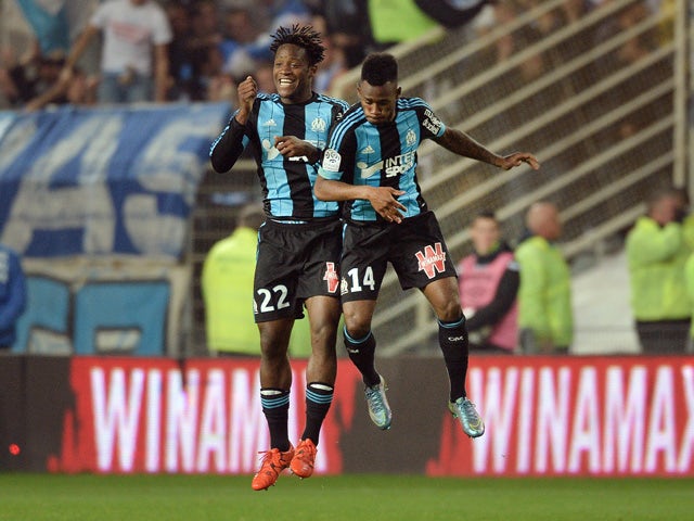 Marseille's French midfielder Georges-Kevin Nkoudou (R) celebrates with Marseille's Belgian forward Michy Batshuayi after scoring a goal during the French L1 football match between Nantes and Marseille at the Beaujoire stadium in Nantes, western France, o