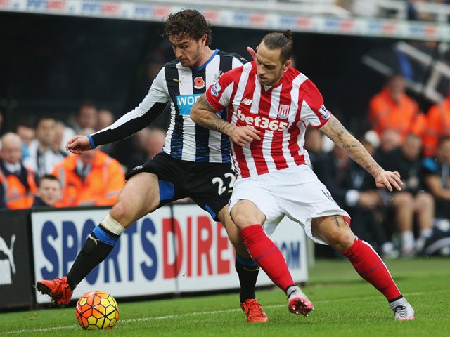 Daryl Janmaat of Newcastle United and Marko Arnautovic of Stoke City compete for the ball during the Barclays Premier League match between Newcastle United and Stoke City at St James' Park on October 31, 2015