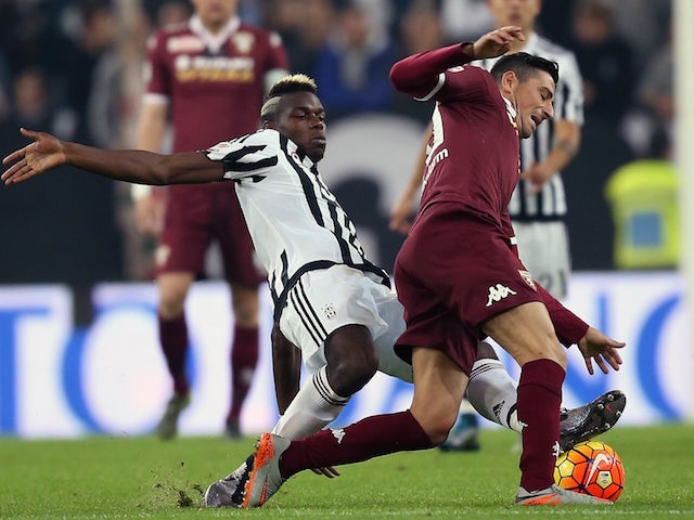 Juventus' French midfielder Paul Pogba (L) vies for the ball with Torino's Italian midfielder Giuseppe Vives during the Italian Serie A football match between Juventus and Torino on October 31, 2015 at the 'Juventus Stadium' in Turin. 