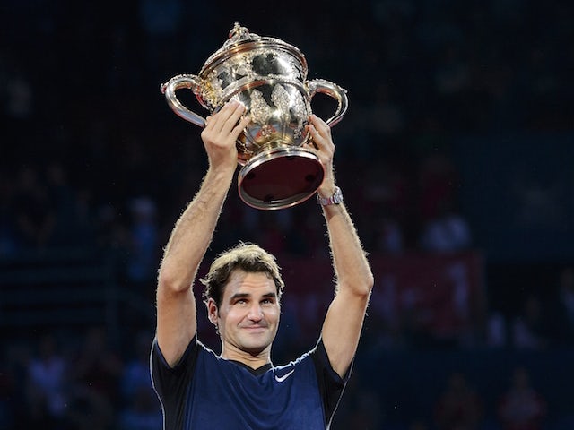 Switzerland's Roger Federer raises his trophy as he celebrates his victory against Spain's Rafael Nadal after their final match at the Swiss Indoors tennis tournament on November 1, 2015 in Basel, northern Switzerland.