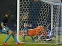 Sheffield Wednesday's English defender Sam Hutchinson (R) beats Arsenal's Czech goalkeeper Petr Cech (C) to score the team's third goal during the English League Cup fourth round football match between Sheffield Wednesday and Arsenal at The Hillsborough S