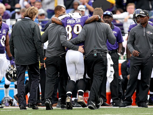 Wide receiver Steve Smith #89 of the Baltimore Ravens is helped off the field by medial staff after being injured in the third quarter against the San Diego Chargers at M&T Bank Stadium on November 1, 2015