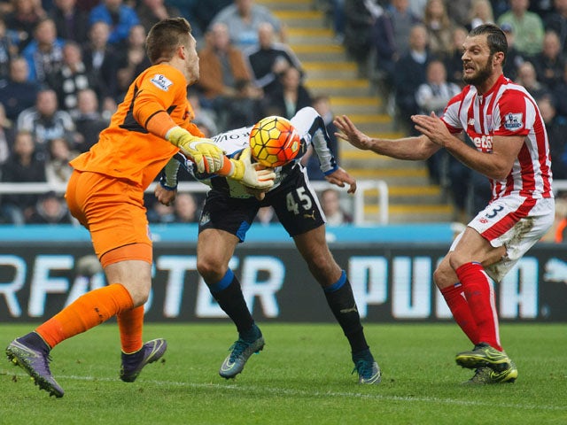 Jack Butland of Stoke City and Aleksandar Mitrovic of Newcastle United compete for the ball during the Barclays Premier League match between Newcastle United and Stoke City at St James' Park on October 31, 2015