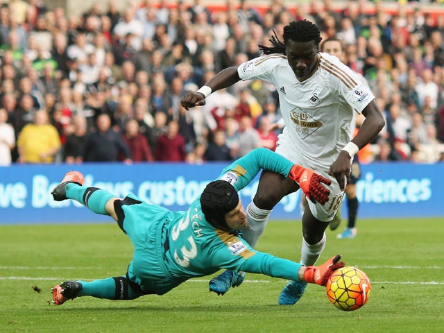 Petr Cech of Arsenal brings down Bafetimbi Gomis of Swansea City during the Barclays Premier League match between Swansea City and Arsenal at Liberty Stadium on October 31, 2015