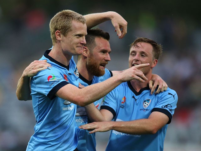 Matt Simon of Sydney FC celebrates with team mates after scoring a goal during the round four A-League match between the Central Coast Mariners and Sydney FC at Central Coast Stadium on October 31, 2015 