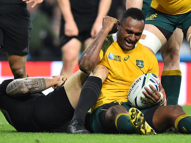 Australia's centre Tevita Kuridrani (R) reacts after scoring his team's second try during the final match of the 2015 Rugby World Cup between New Zealand and Australia at Twickenham stadium, south west London, on October 31, 2015