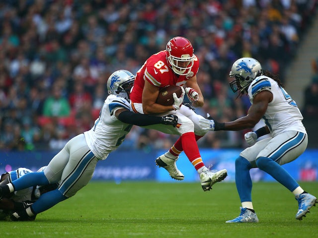 Travis Kelce #87 of the Kansas City Chiefs is tackled by Glover Quin #27 of the Detroit Lions defence during the NFL match between Kansas City Chiefs and Detroit Lions at Wembley Stadium on November 01, 2015 in London, England.