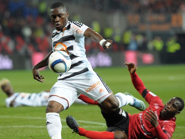 Guingamp's French defender Brou Benhamin Angoua (R) vies with Lorient's Cameroonian forward Waris Majeed during the French Ligue 1 match Guingamp against Lorient on October 31, 2015 at the Roudourou stadium in Guingamp, western France. 