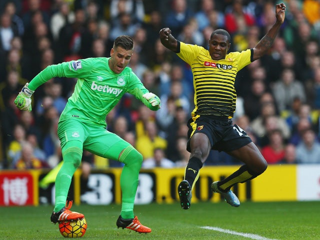 Adrian of West Ham United is challenged by Odion Ighalo of Watford during the Barclays Premier League match between Watford and West Ham United at Vicarage Road on October 31, 2015