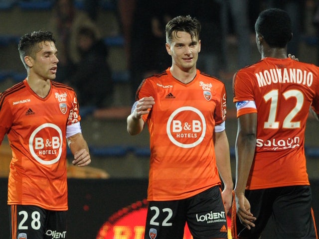 Lorient's French forward Benjamin Jeannot (C) is congratulated by Lorient's French midfielder Maxime Barthelme (L) and Lorient's Cameroonian forward Benjamin Moukandjo after scoring a goal during the French Ligue 1 match Lorient against Troyes November 7,