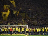 Dortmund's players celebrate with the fans after the German first division football Bundesliga match Borussia Dortmund vs FC Schalke 04 on November 8, 2015, 2015 in Dortmund, western Germany. Dortmund won the derby 3-2.
