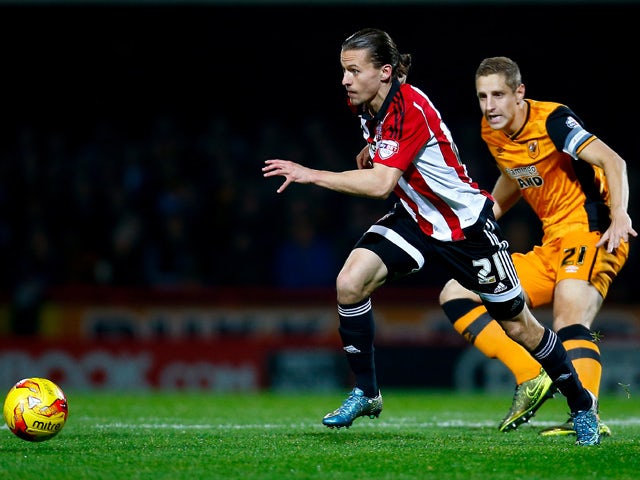 Lasse Vibe of Brentford takes the ball past Michael Dawson of Hull during the Sky Bet Championship match between Brentford and Hull City on November 3, 2015