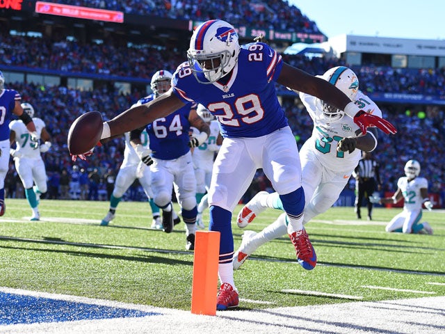 Karlos Williams #29 of the Buffalo Bills scores a touchdown past Michael Thomas #31 of the Miami Dolphins during the first half at Ralph Wilson Stadium on November 8, 2015