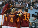 Edin Dzeko of AS Roma with team mates celebrate him scoring the opening goal from penalty spot during the Serie A match between AS Roma and SS Lazio at Stadio Olimpico on November 8, 2015 in Rome, Italy. 