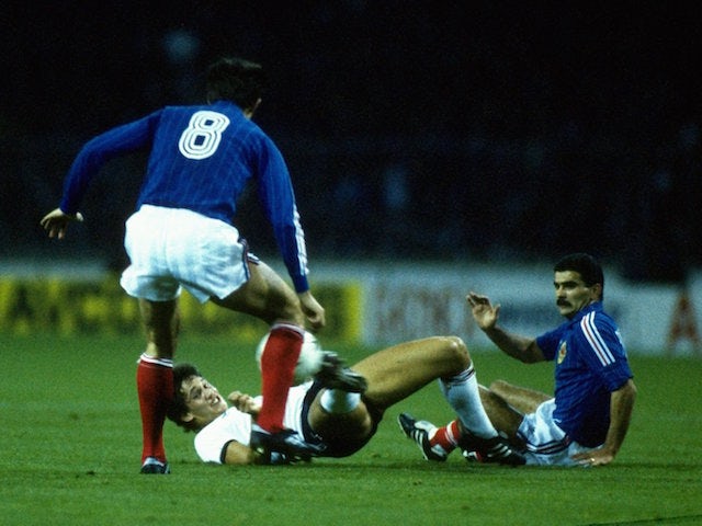 Gary Lineker of England slips as he tackles Jankovic of Yugoslavia during the European Championship qualifying match at Wembley Stadium in London. England won the match 2-0.