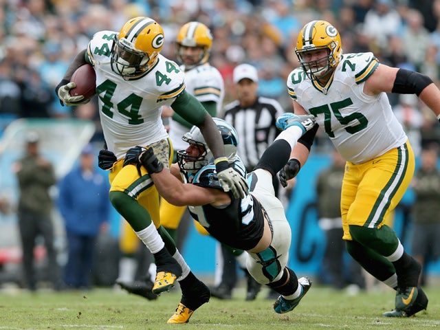 James Starks #44 of the Green Bay Packers runs the ball against Luke Kuechly #59 of the Carolina Panthers in the 1st quarter during their game at Bank of America Stadium on November 8, 2015