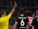 Dutch referee Bjoern Kuipers shows the red card to Juventus' Brazilian midfielder Hernanes (hidden) during the UEFA Champions League Group D football match between Borussia Moenchengladbach and Juventus in Moenchengladbach, western Germany on November 3, 