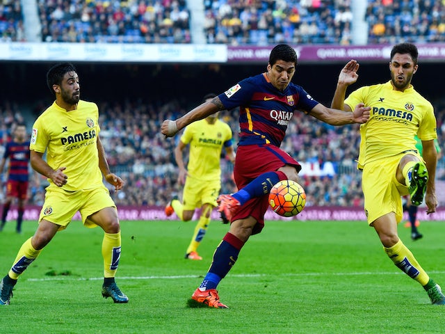 Luis Suarez of FC Barcelona competes for the ball with Villarreal CF players during the La Liga match between FC Barcelona and Villarreal CF at Camp Nou on November 8, 2015 in Barcelona, Spain.