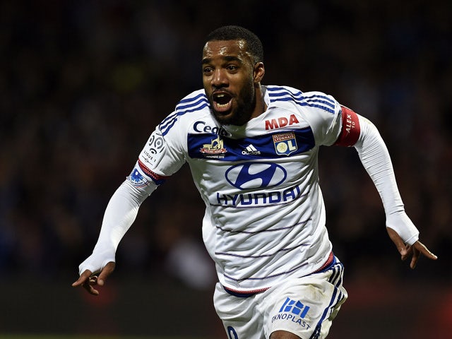 Lyon's French forward Alexandre Lacazette celebrates after scoring a second goal during the French L1 football match between Lyon and Saint-Etienne at the Gerland stadium in Lyon, southeastern France, on November 8, 2015