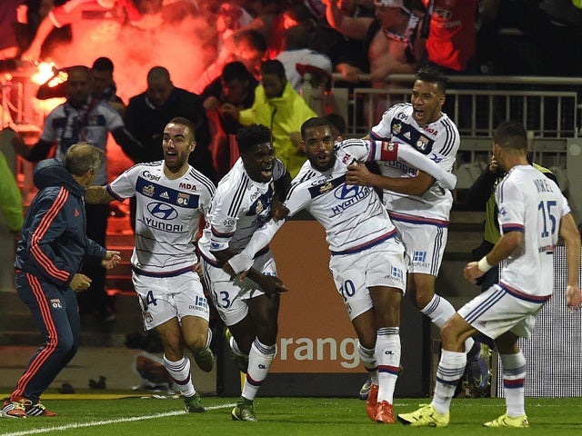 Lyon's French forward Alexandre Lacazette (C) celebrates with teammates after scoring a goal during the French L1 football match between Lyon and Saint-Etienne at the Gerland stadium in Lyon, southeastern France, on November 8, 2015