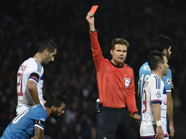 Lyon's French midfielder Maxime Gonalons (L) receives a red card by the referee during an UEFA Champions League Group H football match between Lyon and Zenit Saint-Petersburg at the Stade de Gerland stadium in Lyon, southeastern France on November 4, 2015