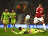Manchester United's English midfielder Jesse Lingard (R) jumps a tackle by CSKA Moscow's midfielder Alan Dzagoev during a UEFA Chamions league group stage football match between CSKA Moscow and Manchester United at Old Trafford in Manchester, north west E