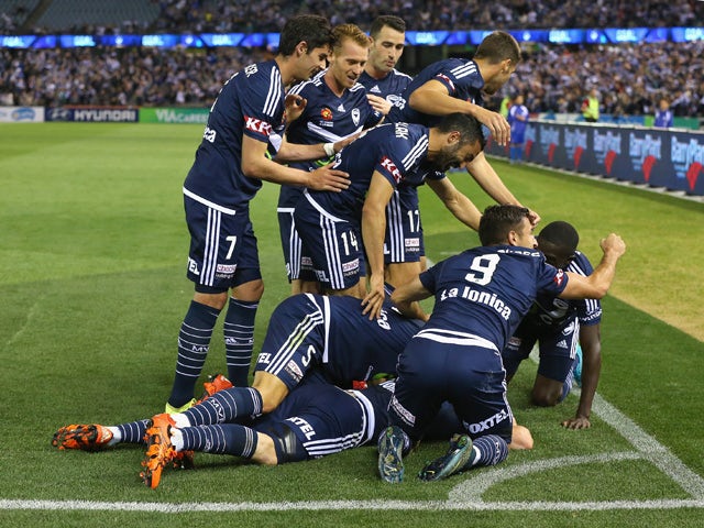 Besart Berisha of the Victory is congratulated by team mates after scoring a goal during the round four A-League match between the Melbourne Victory and Wellington Phoenix at Etihad Stadium on November 2, 2015