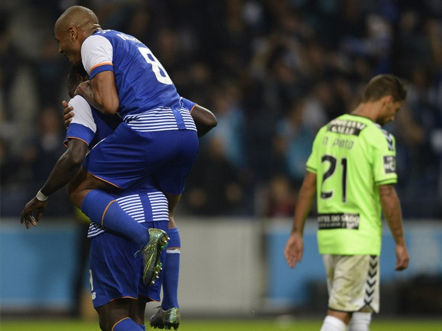 Porto's Cameroonian forward Vincent Aboubakar (L) is congratulated by teammate Algerian midfielder Yacine Brahimi after scoring a goal during the Portuguese league football match FC Porto vs Vitoria Setubal FC at the Dragao stadium in Porto on November 8,