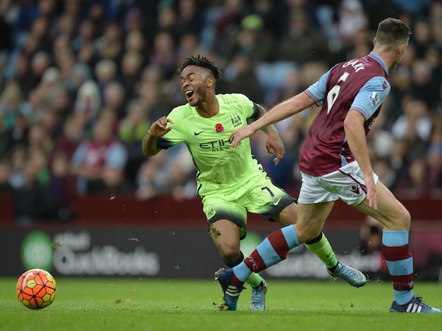 Manchester City's English midfielder Raheem Sterling (L) falls after a challenge from Aston Villa's English-born Irish defender Ciaran Clark in the penalty area during the English Premier League football match between Aston Villa and Manchester City at Vi