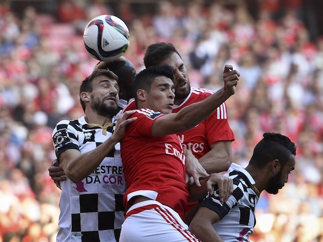 Benfica's Mexican forward Raul Rodriguez (C) heads the ball with Boavista's defender Nuno Henrique (L) during the Portuguese league football match SL Benfica vs Boavista FC at the Luz stadium in Lisbon on November 8, 2015.