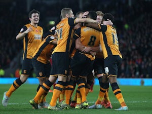 Tom Huddlestone of Hull City is congratulated by his team-mates after scoring his side's third goal during the Sky Bet Championship match between Hull City and Middlesbrough at the KC Stadium on November 7, 2015 in Hull, England.