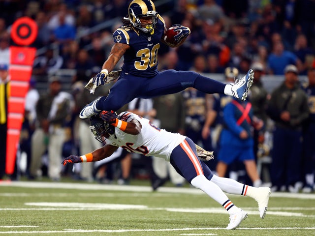 Todd Gurley #30 of the St. Louis Rams leaps over Antrel Rolle #26 of the Chicago Bears as he carries the ball in the first quarter at the Edward Jones Dome on November 15, 2015