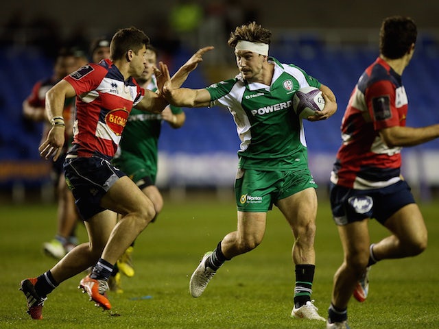 Dominic Waldouck of London Irish hands off the tackle of Julien Heriteau of Agen during the European Rugby Challenge Cup match between London Irish and Agen at Madejski Stadium on November 14, 2015 in Reading, England.