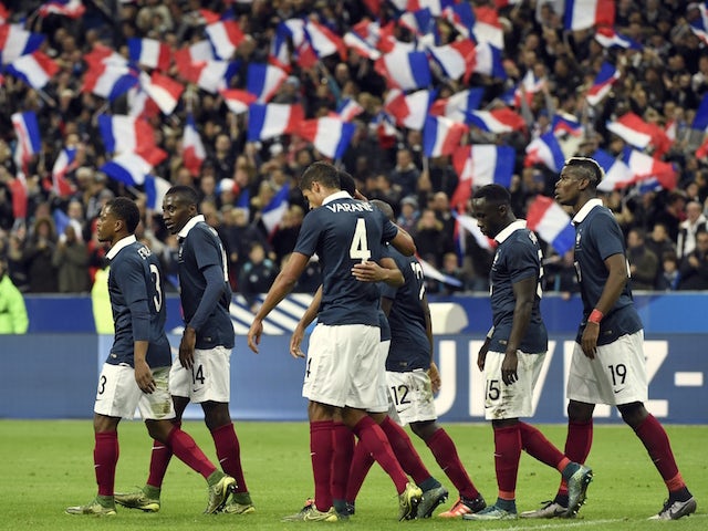 France's players celebrate after opening the scoring during a friendly international football match between France and Germany ahead of the Euro 2016, on November 13, 2015 at the Stade de France stadium in Saint-Denis, north of Paris.