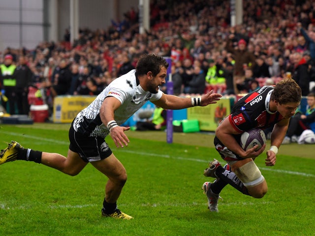 Gloucester wing Henry Purdy crosses for the first try as Zebra fullback Guglielmo Palazzani looks on during the European Rugby Challenge Cup match between Gloucester and Zebra at Kingsholm Stadium on November 14, 2015
