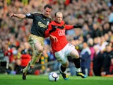 Wayne Rooney (R) of Manchester United battles Jamie Carragher of Liverpool during the Barclays Premier League match between Manchester United and Liverpool at Old Trafford on March 21, 2010