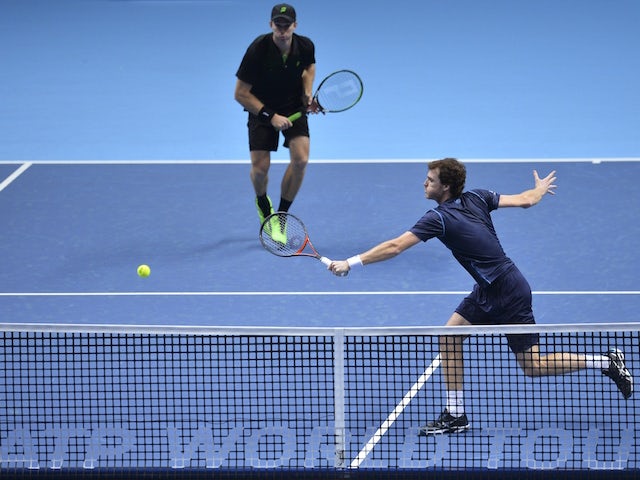 Australia's John Peers (back) stands by as his partner Britain's Jamie Murray (front) returns against Italy's Simone Bolelli and Italy's Fabio Fognini during their men's doubles group stage match on day one of the ATP World Tour Finals tennis tournament i